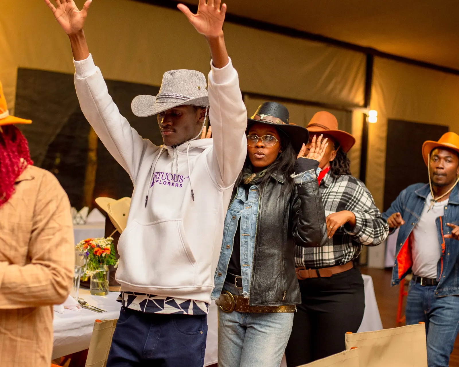 Guests dancing at a themed cowboy night under festoon lights at Mtalii Bush Camps