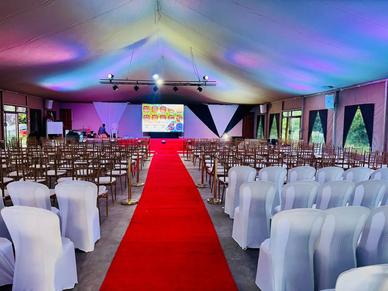 A large marquee event at Mtalii set with a stage, red carpet and seating for hundreds