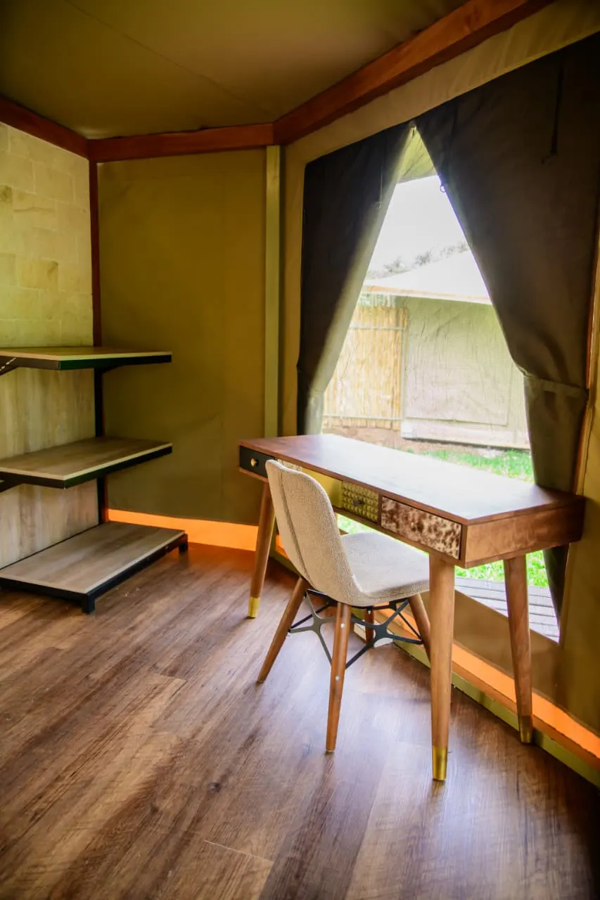 A writing desk at the canvas window of a Mtalii tented suite